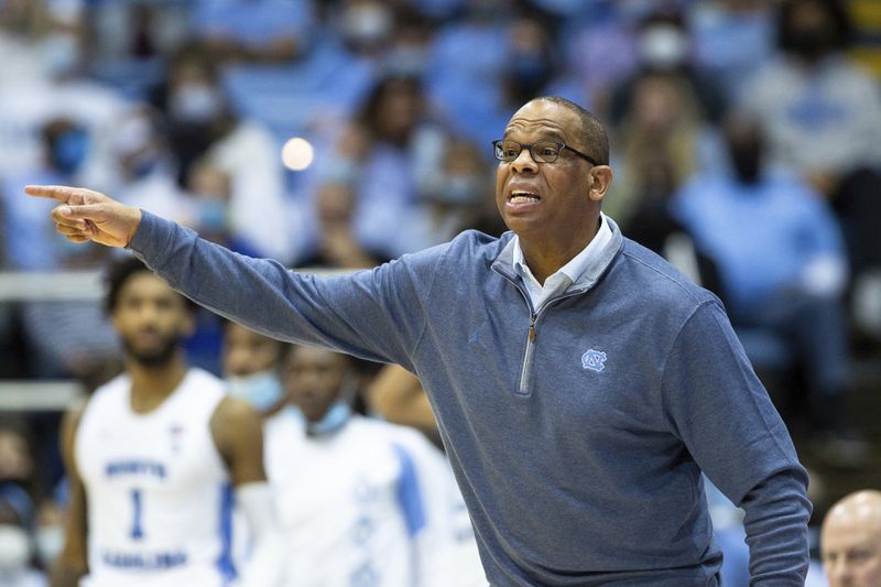 FILE - North Carolina Head Coach Hubert Davis shouts to his team during the second half of an NCAA college basketball game against Appalachian State in Chapel Hill, N.C., Dec. 21, 2021. (AP Photo/Ben McKeown, File)