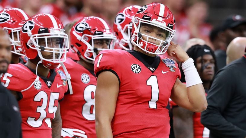 NEW ORLEANS, LA - JANUARY 01: Ohio State Buckeyes quarterback Justin Fields  (1) is tended to by medical staff after a targeting hit to his back during  the Allstate Sugar Bowl College