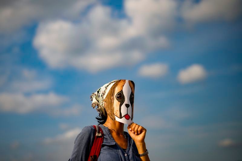 A woman wears a mask during a protest against a bill approved by Turkish legislators that aims to remove stray dogs off the country's streets, in Istanbul, Turkey, Sunday, Sept. 1, 2024. (AP Photo/Emrah Gurel)