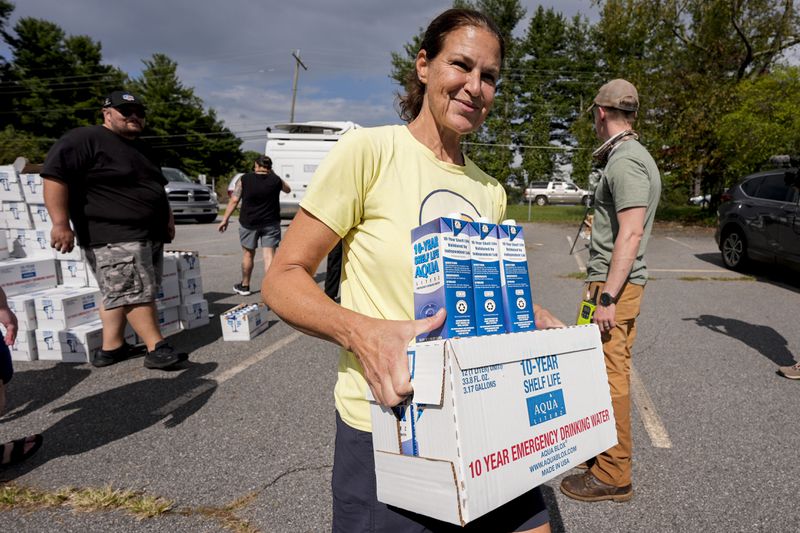 Volunteers stage water for citizens in the aftermath of Hurricane Helene, Monday, Sept. 30, 2024, in Asheville, N.C. (AP Photo/Mike Stewart)