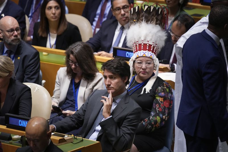 Canadian Prime Minister Justin Trudeau listens to speakers during the 79th session of the United Nations General Assembly at United Nations headquarters, Tuesday, Sept. 24, 2024. Sitting behind him is Canada's National Chief of the Assembly of First Nations Cindy Woodhouse Nepinak. (AP Photo/Seth Wenig)