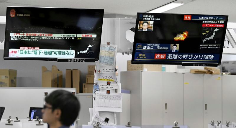 TV monitors show a report on a rocket launch by North Korea, in Tokyo Monday, May 27, 2024. Japan's government briefly issued a missile warning for the southern prefecture of Okinawa, urging residents to take shelter inside buildings and other safer places. The warning was lifted later because the region was no longer in danger, Chief Cabinet Secretary Yoshimasa Hayashi said. (Kyodo News via AP)