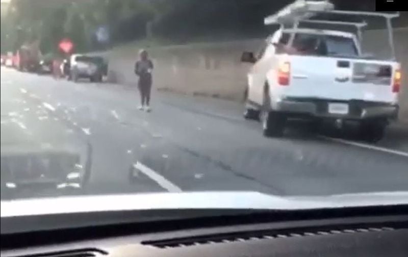 Drivers stopping to grab cash spilled from a GardaWorld armored truck on I-285 in Dunwoody on July 9. SOCIAL MEDIA POST