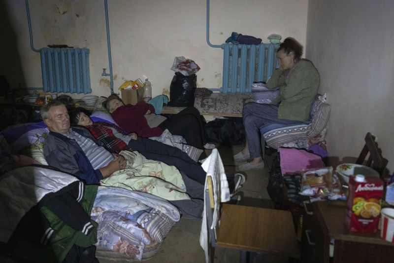 Local residents hide in a basement in Sudzha, Kursk region, Russia, Friday, Aug. 16, 2024. This image was approved by the Ukrainian Defense Ministry before publication. (AP Photo)