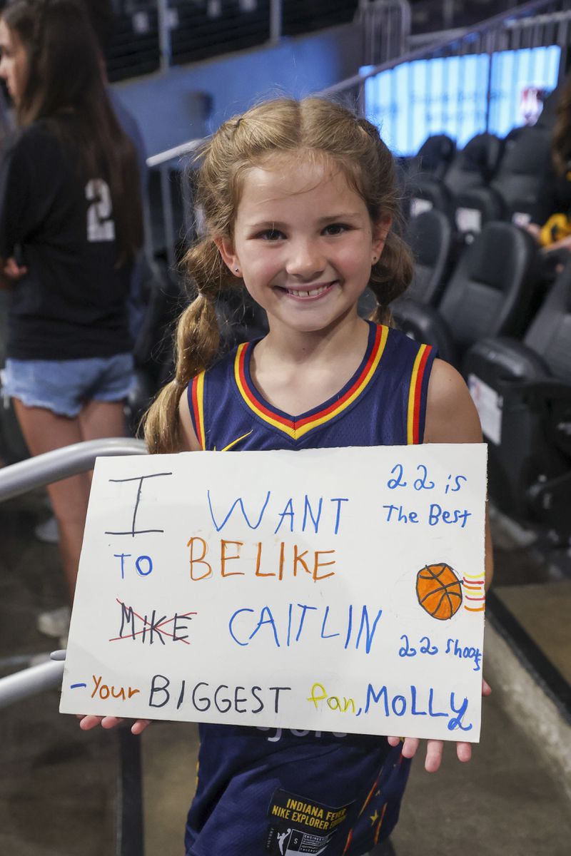 Eight-year-old Molly James, of Acworth, Ga., holds her handmade sign she made for Indiana Fever guard Caitlin Clark before the Fever game against the Atlanta Dream at State Farm Arena, Friday, June 21, 2024, in Atlanta. (Jason Getz / AJC)
