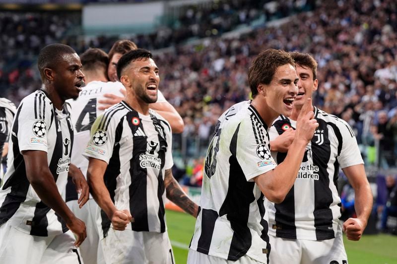 Juventus' Kenan Yildiz, second from right, celebrates after scoring the opening goal during the Champions League opening phase soccer match between Juventus and PSV Eindhoven at the Juventus stadium in Turin, Italy, Tuesday, Sept. 17, 2024. (Fabio Ferrari/LaPresse via AP)