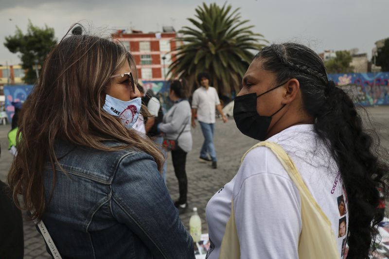 Veronica Rosas, left, and Dionicia Pelcastre, who both have missing sons, Diego and Guillermo, visit before attending an Anglican Mass with members of their search collective "Uniendo Esperanzas" or Uniting Hope, in Mexico City, Sunday, July 21, 2024. (AP Photo/Ginnette Riquelme)