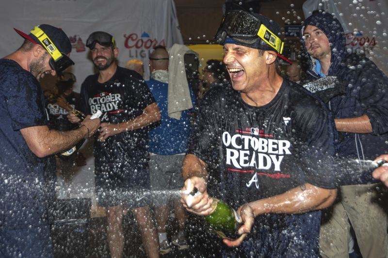 The Atlanta Braves celebrate in the locker room after clinching a wild-card playoff berth after the second baseball game of a doubleheader against the New York Mets, Monday, Sept. 30, 2024, in Atlanta. (AP Photo/Jason Allen)