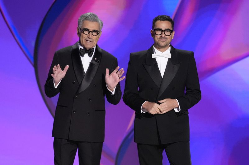 Hosts Eugene Levy, left, and Dan Levy speak during the 76th Primetime Emmy Awards on Sunday, Sept. 15, 2024, at the Peacock Theater in Los Angeles. (AP Photo/Chris Pizzello)