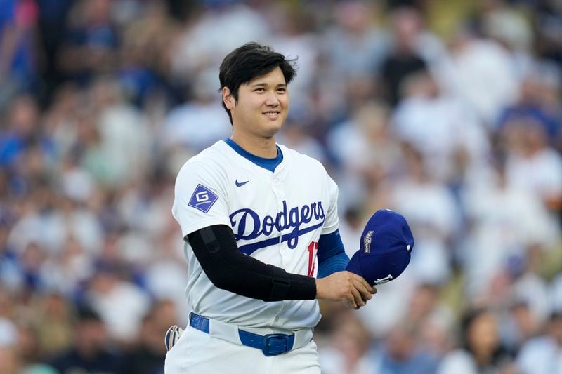 Los Angeles Dodgers' Shohei Ohtani walks back to the dugout before Game 1 of baseball's NL Division Series against the San Diego Padres, Saturday, Oct. 5, 2024, in Los Angeles. (AP Photo/Ashley Landis)