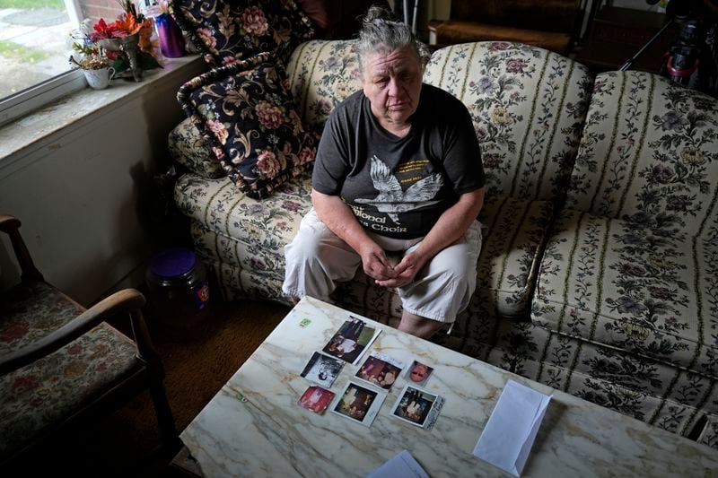 Suzy Patton shows old photos of her brother Steve Szarewicz, who insists he was wrongly convicted of a 1981 murder based on the testimony of four jailhouse informants, on Tuesday, April 30, 2024, in her home in New Kensington, Pa. (AP Photo/Gene J. Puskar)