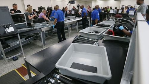 May 25, 2016 - Atlanta - Powered rollers transport bags automatically through the screening process. TSA unveiled new security "smart lanes" that have been installed in the South Security Checkpoint, which feature automated equipment that handles baggage. BOB ANDRES / BANDRES@AJC.COM