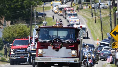 A Saxonburg, Pa. fire truck carrying the casket of Cory Comperatore, leads a procession of fire vehicles following a memorial service at Cabot United Methodist Church in Cabot, Pa., Friday, July 19, 2024. Comperatore, a former fire chief, was shot and killed at a rally where a gunman tried to assassinate former President Donald Trump. (AP Photo/Gene J. Puskar)