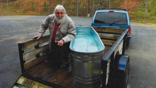 Rockmart evangelist Stephen Jarrard uses a horse trough to baptize jail inmates seeking salvation. He notched a win Monday in his legal fight for inclusion in the Polk County Jail ministry program.