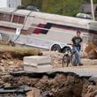 Dominick Gucciardo walks to his home in the aftermath of Hurricane Helene, Thursday, Oct. 3, 2024, in Pensacola, N.C. (AP Photo/Mike Stewart)