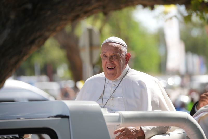 Pope Francis in the car, is welcomed in Dili, East Timor, Monday, Sept. 9, 2024. (AP Photo/Dita Alangkara)