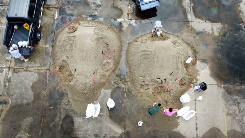 St. Bernard Parish residents fill sandbags in the old Kmart/Sears parking lot ahead of Tropical Storm Francine, Monday, Sept. 9, 2024, in Chalmette, La. (David Grunfeld/The Times-Picayune/The New Orleans Advocate via AP)