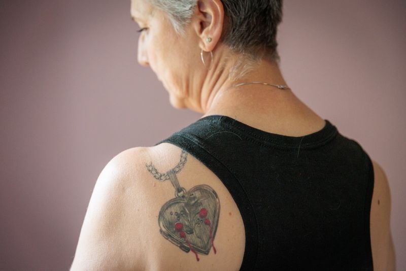 Michelle Cleveland says that her tattoo, featuring semicolons, represents continuation rather than ending. She says people frequently reach out to her for guidance. “They’re desperate. There’s not enough help. They don’t know what to do.”
(Arvin Temkar / arvin.temkar@ajc.com)