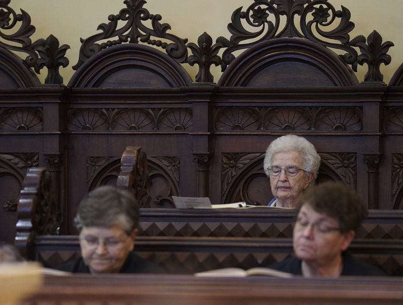 Benedictine sisters sit in silence during evening prayer at the Mount St. Scholastica monastery in Atchison, Kan., Tuesday, July 16, 2024. (AP Photo/Jessie Wardarski)