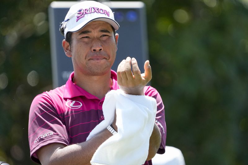 Hideki Matsuyama, of Japan, dries his hands on the 18th tee during the second round of the St. Jude Championship golf tournament Friday, Aug. 16, 2024, in Memphis, Tenn. (AP Photo/Mark Humphrey)