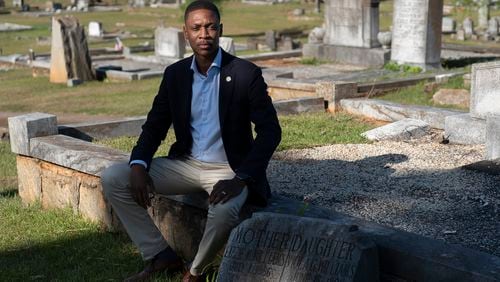 Atlanta Councilmember Jason Winston sits in the original section of the South-View Cemetery Friday, June 21, 2024. Winston secured funding for the cemetery, chartered in 1886 by formerly enslaved people, to apply to the National Register of Historic Places. (Ben Gray / Ben@BenGray.com)