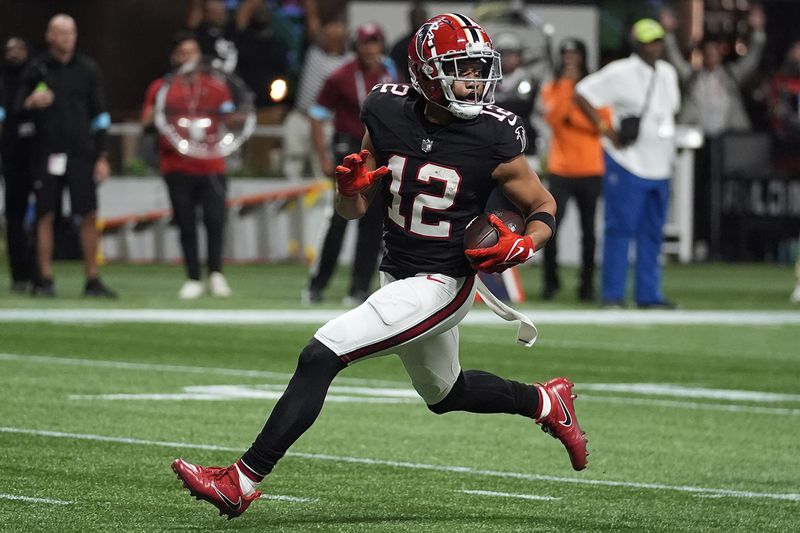 Atlanta Falcons wide receiver KhaDarel Hodge (12) scores the game-wining touchdown against the Tampa Bay Buccaneers during overtime in an NFL football game Thursday, Oct. 3, 2024, in Atlanta. (AP Photo/John Bazemore)