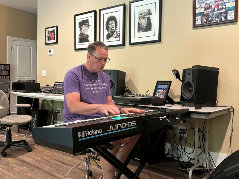 GHSA executive director Robin Hines plays the keyboard in his music room at his home in Hartwell, April 3, 2024.