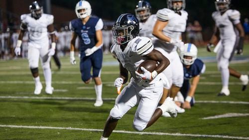 Christian Isibor, running back for Cambridge, rushes the ball during the Cambridge v. Alpharetta high school football game on Friday, September 2, 2022, at Cambridge High School in Milton, Georgia. Alpharetta defeated Cambridge 43-38. CHRISTINA MATACOTTA FOR THE ATLANTA JOURNAL-CONSTITUTION.