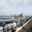 This handout photo from the U.S. Navy shows the Henry J. Kaiser-class fleet replenishment oiler USNS Big Horn sailing alongside the aircraft carrier USS Abraham Lincoln on Sept. 11, 2024, at an undisclosed location at sea in the Middle East. The Big Horn sustained damage in an incident which is under investigation, officials said Tuesday, Sept. 24, 2024. (U.S. Navy via AP)