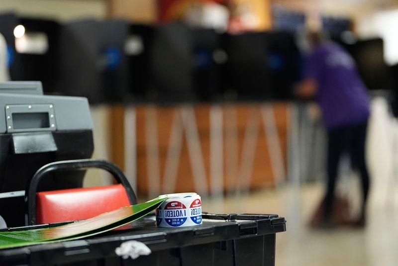 FILE - Stickers reading "I voted" rest beside a ballot scanner as a voter fills in a ballot at a privacy booth, during voting in Florida's primary election, Tuesday, Aug. 20, 2024, in a voting bureau at the American Legion in South Miami, Fla. (AP Photo/Rebecca Blackwell, File)