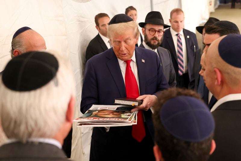 Republican presidential nominee former President Donald Trump talks with members of the Chabad Lubavitch after visiting the gravesite of Rabbi Menachem Mendel Schneerson, Monday, Oct. 7, 2024, in New York. (AP Photo/Yuki Iwamura)