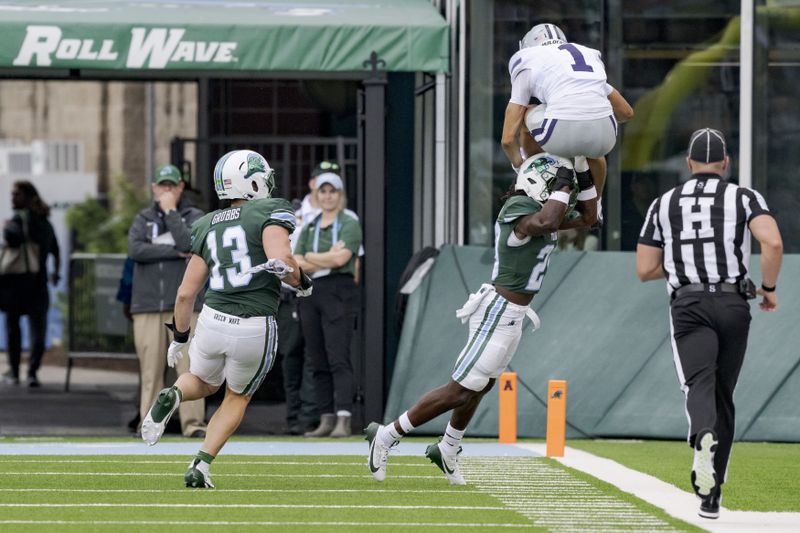 Kansas State wide receiver Jayce Brown (1) leaps for the end zone but is pushed out-of-bounds by Tulane safety Jack Tchienchou (29) during the first half of an NCAA college football game in New Orleans, Saturday, Sept. 7, 2024. (AP Photo/Matthew Hinton)