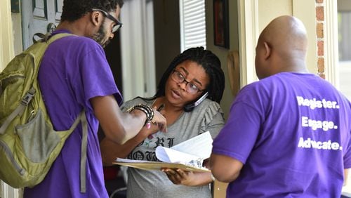 Rodney King (left), volunteer with New Georgia Project and Corbin Spencer (right), field director of New Georgia Project, help Rueke Uyunwa registering to vote for the District 6 runoff on Wednesday, May 17, 2017. HYOSUB SHIN / HSHIN@AJC.COM