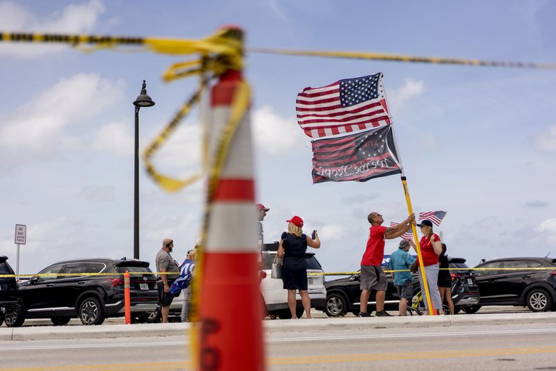 
                        Trump supporters outside of the Mar-a-Lago Club in Palm Beach, Fla., on Friday, March 31, 2023. The voters who will pick the 2024 G.O.P. nominee expressed anger, defensiveness and also embarrassment about the indictment facing Trump. (Josh Ritchie/The New York Times)
                      