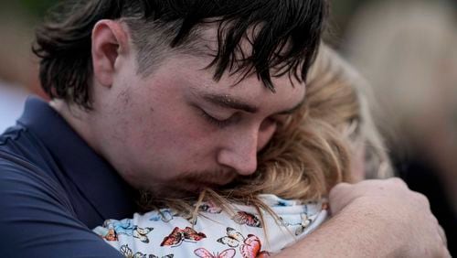 Mourners pray during a candlelight vigil for the slain students and teachers at Apalachee High School, Wednesday, Sept. 4, 2024, in Winder, Ga. (AP Photo/Mike Stewart)