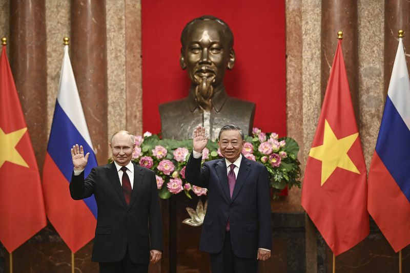 Russian President Vladimir Putin, left, and Vietnam's President To Lam pose for photos at the Presidential Palace in Hanoi, Vietnam Thursday, June 20, 2024. (Nhac Nguyen/Pool Photo via AP)