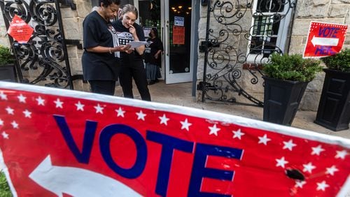 Cathy Anderson (left) goes over some last minute preparation with poll manager, Alex (right) at the polling place at the Park Tavern located at 500 10th Street NE in Atlanta on Tuesday, May 21, 2024. (John Spink/AJC)