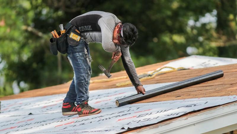 RCB Roofing's Miguel Lopez wipes the sweat away as he and his crew put on a new roof of an Atlanta resident on Thursday, July 20, 2023. Last year was the hottest year on record globally. (John Spink / John.Spink@ajc.com)


