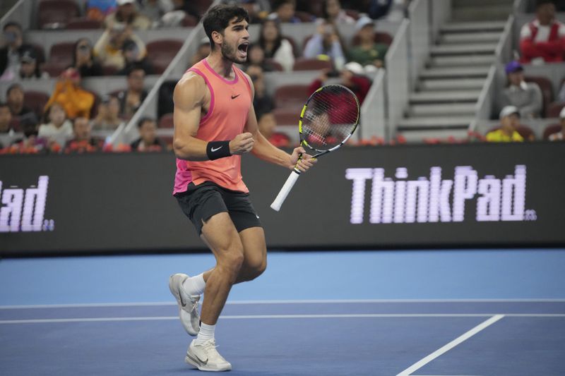 Carlos Alcaraz of Spain reacts after defeating Daniil Medvedev of Russia in a men's singles semi-final match for the China Open tennis tournament held at the National Tennis Center in Beijing, Tuesday, Oct. 1, 2024. (AP Photo/Achmad Ibrahim)