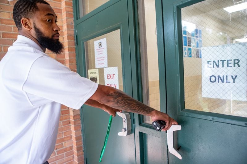 DeKalb County School District elementary security associate Vincent Rhynes makes his rounds at Ashford Park Elementary on Monday, Sept. 16, 2024, where he checks all locked doors, looks in on classrooms and walks the perimeter of the property. (Jenni Girtman for the AJC)