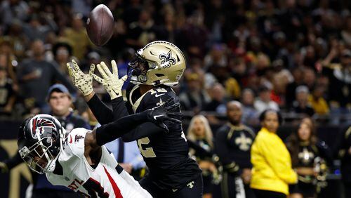 New Orleans Saints wide receiver Chris Olave (12) makes a touchdown catch against Atlanta Falcons cornerback Clark Phillips III (34) in the second half of an NFL football game in New Orleans, Sunday, Jan. 7, 2024. (AP Photo/Butch Dill)