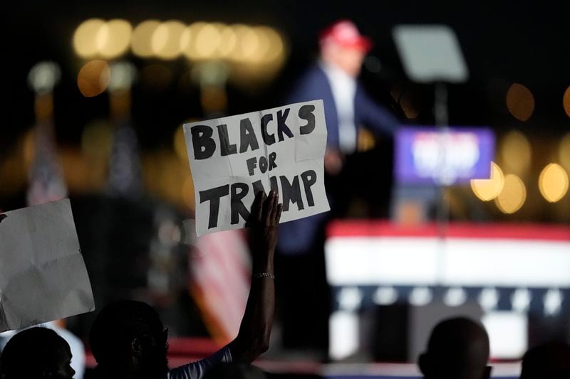 FILE - A supporter holds up a sign as Republican presidential candidate former President Donald Trump speaks at a campaign rally at Trump National Doral Miami, July 9, 2024, in Doral, Fla. (AP Photo/Rebecca Blackwell, File)