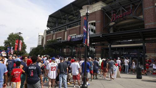 Atlanta Braves fans wait in line outside of the third base gate at Truist Park, Tuesday, August 6, 2024, in Atlanta. Fans waited in line for the gates to open to receive an OutKast bobblehead, featuring duo Big Boi and Andre 3000. The first 15,000 fans received this bobblehead. (Jason Getz / AJC)
