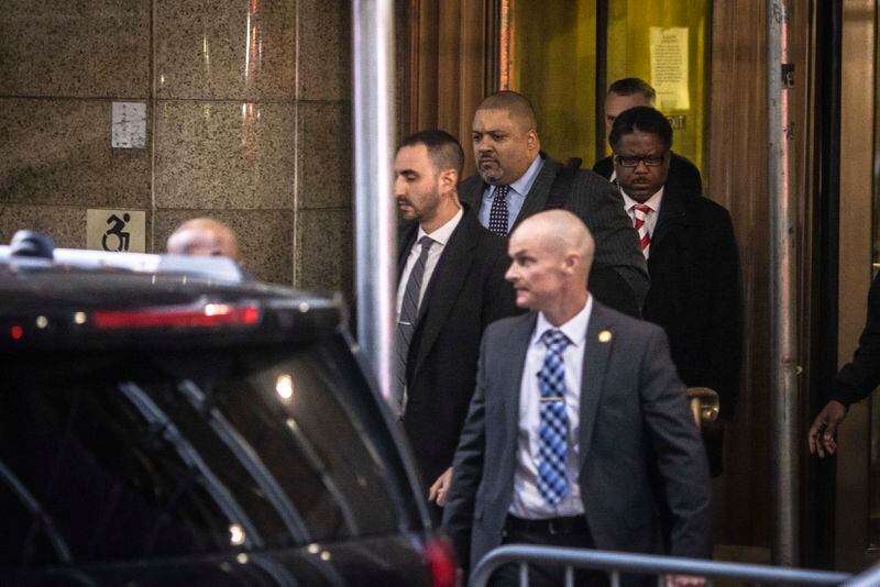 
                        Alvin Bragg, top center, Manhattan District Attorney, leaves his office after a grand jury indicted former President Donald Trump over a $130,000 hush-money payment to porn star Stormy Daniels, March 30, 2023. A year ago, the investigation into the former president appeared to be over, but a series of crucial turning points led to this week’s indictment. (Dave Sanders/The New York Times)
                      