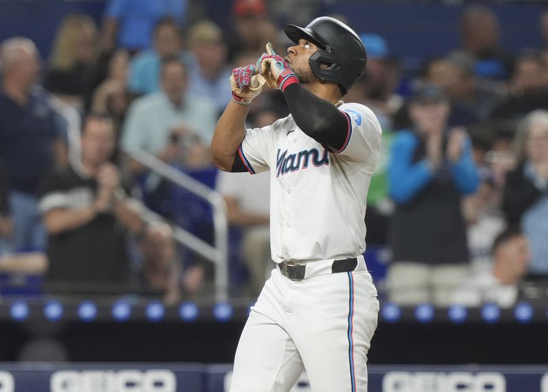 Miami Marlins' Otto Lopez gestures after hitting a home run during the third inning of a baseball game against the Los Angeles Dodgers, Tuesday, Sept. 17, 2024, in Miami. (AP Photo/Marta Lavandier)