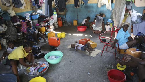 Families displaced by gang violence do laundry inside a school where they have been taking refuge for over a year in Port-au-Prince, Haiti, Friday, Sept. 20, 2024. (AP Photo/Odelyn Joseph)