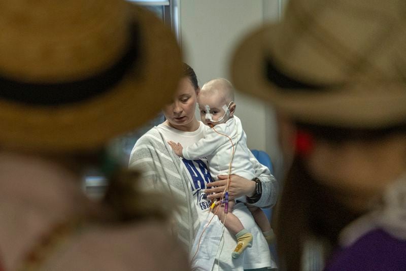 Michael Bilyk, is held by his mother Antonina Malyshko, as he is visited by Zhuzha and Lala from the volunteer group the "Bureau of Smiles and Support" at Okhmatdyt children's hospital in Kyiv, Ukraine, Thursday Sept. 19, 2024. (AP Photo/Anton Shtuka)