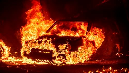 Flames consume a vehicle as the Park Fire jburns in Tehama County, Calif., on Friday, July 26, 2024. (AP Photo/Noah Berger)