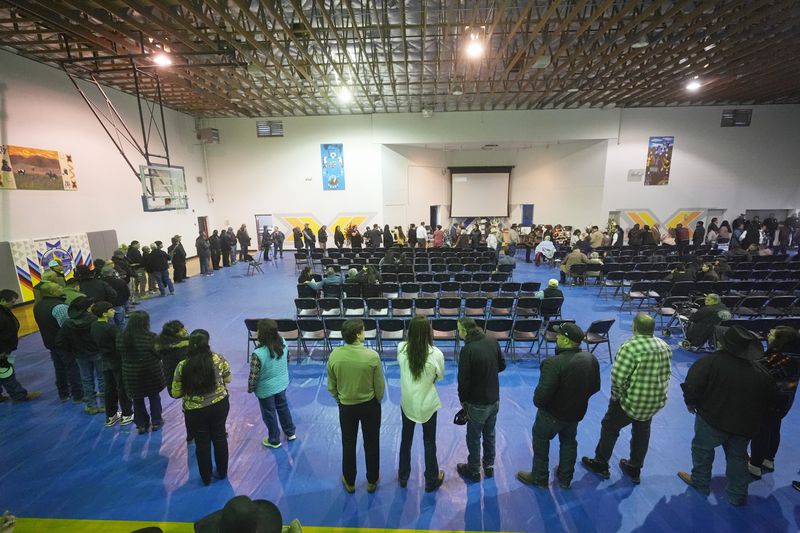 Tribal members gather in a gymnasium to pay their respects to Marvin Cota, who died from cancer, during a memorial service in Owyhee, Nev., on March 14, 2024, on the Duck Valley Indian Reservation that straddles the Nevada-Idaho border. (AP Photo/Rick Bowmer)