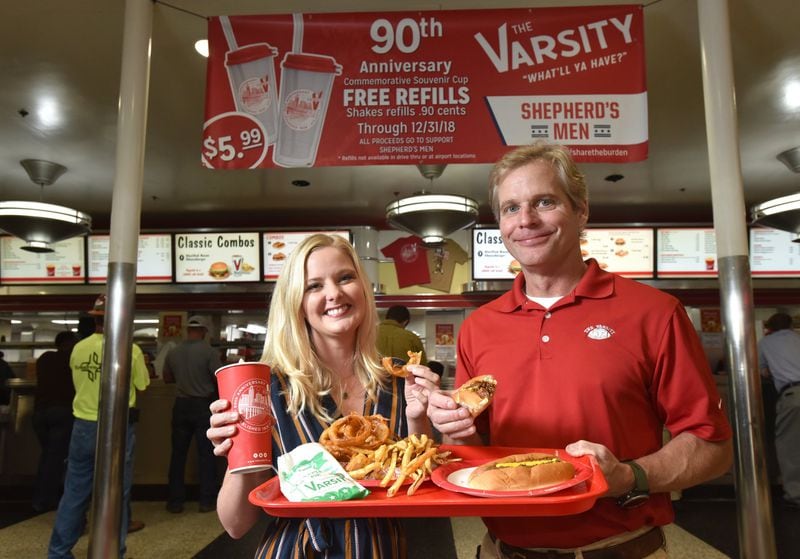 The Varsity is still in the blood of founder Frank Gordy’s family. Grandson Gordon Muir is president of the Varsity, and Muir’s daughter Ashley Weiser is head of marketing. They’re shown at the Varsity in Midtown Atlanta. The Varsity is turning 90, and as part of the anniversary, they’re raising $90,000 to support a program at the Shepherd Center to help brain-injured veterans. HYOSUB SHIN / HSHIN@AJC.COM